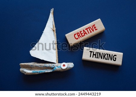 Creative thinking symbol. Wooden blocks with words Creative thinking. Beautiful deep blue background with boat. Business and Creative thinking concept. Copy space.