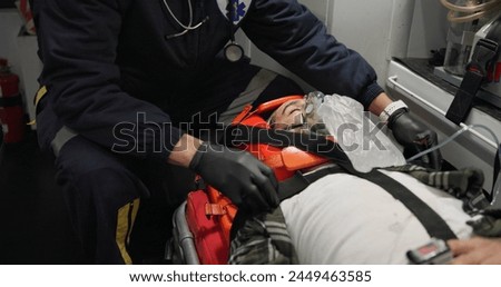 Patient, medic and man with oxygen mask in ambulance for emergency, injury or healthcare with neck brace. First responder, 911 and person with anesthesia for medical health, support or victim check