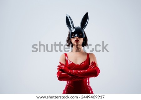 Photo of gorgeous girl folded hands confident pose rabbit mask red leather outfit isolated on light gray background