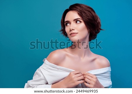 Photo of young woman undress her white shirt seductive looking empty space bedroom isolated on blue color background Royalty-Free Stock Photo #2449469935