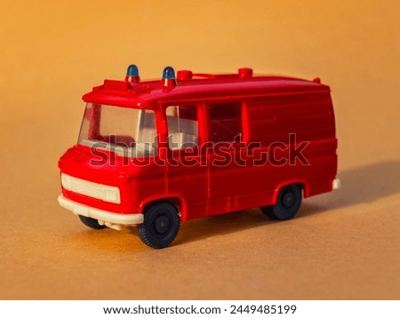 Plastic van red model on sand background toy for children