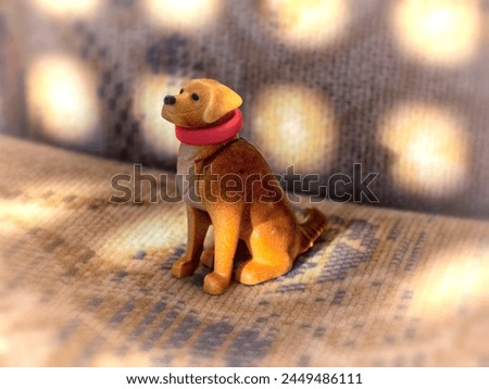 Plastic handmade dog in a red collar