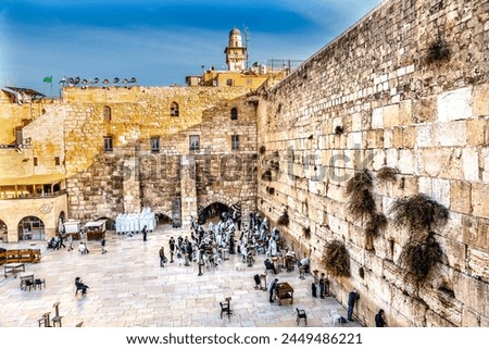 Praying at the Western"Wailing" Wall of Ancient Temple Jerusalem Israel. Western wall of Ancient Jewish Temple built in 100BC on Temple Mount.  Judaisim's most holy site Royalty-Free Stock Photo #2449486221