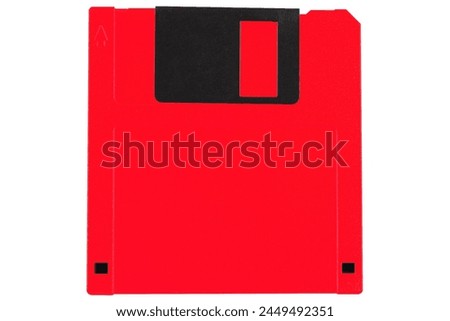 Red colored old retro floppy diskette. Isolated on white background.