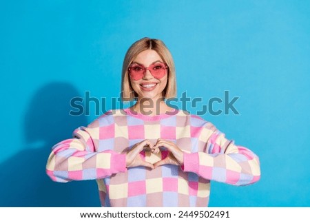 Photo portrait of pretty young girl sunglass celebrate party show heart gesture wear trendy pink outfit isolated on blue color background