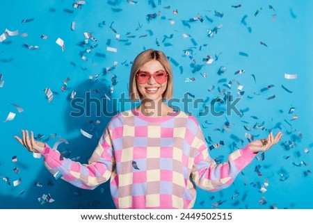 Photo portrait of pretty young girl sunglass celebrate party falling confetti wear trendy pink outfit isolated on blue color background