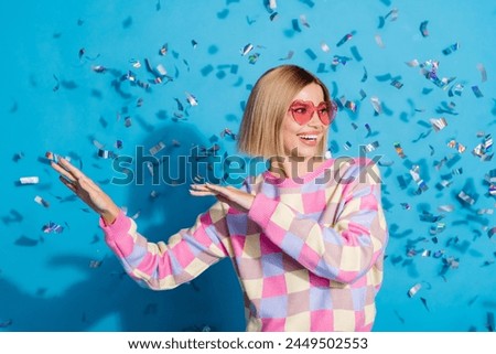 Photo of pretty young girl sunglass celebrate party dancing confetti wear trendy pink outfit isolated on blue color background