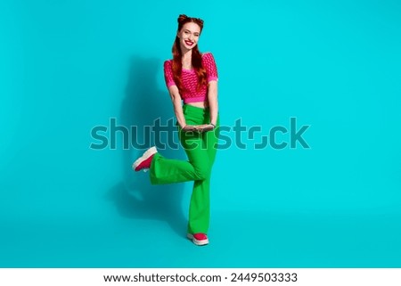 Full length photo of dreamy excited lady dressed pink knitted shirt dancing emtpy space isolated blue color background