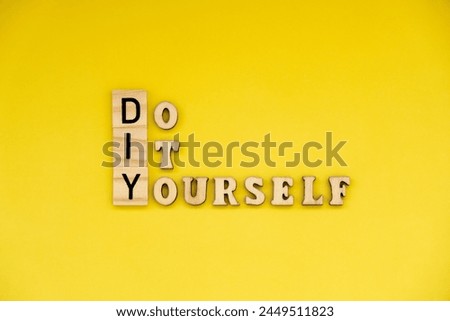 DIY Do It Yourself inscription on yellow background. Handmade home repair decorating handicraft. Tactile creative hobby concept