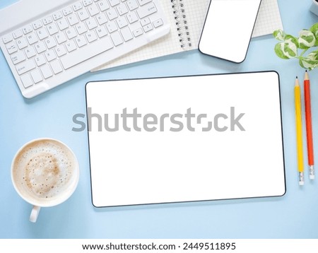 Top view, flat lay template, mock-up digital tablet pc computer with blank white screen and coffee cup, smartphone, keyboard, pencil on blue workplace.
Business, technology concept.
