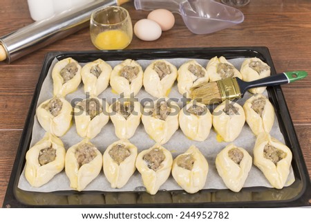 pies made for proofing and smeared egg Royalty-Free Stock Photo #244952782