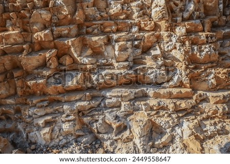 Rough stone background in a quarry closeup for texture design.Interesting background picture of a rock surface