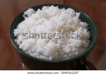 One bowl of white rice on a brown wooden table, food, stock photo.