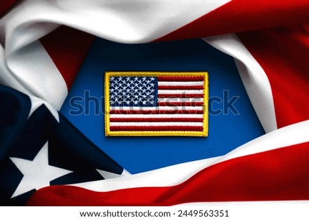Happy Independence day July 4th. Closeup of American flag textile patch and American flag over blue background