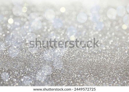 Shiny silver glitter as background. Bokeh effect