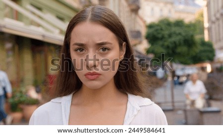 Close up Caucasian unhappy girl street city annoyed woman frowning emotions displeased disappointed dissatisfied angry female envy irritation bad reaction serious expression confident negative pensive Royalty-Free Stock Photo #2449584641