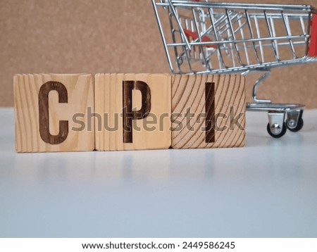 CPI, consumer price index concept. Wooden block with the words CPI on coins stack