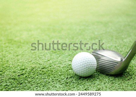 The image of the golf ball and tee placed on artificial grass is not prepared for playing sports. It is placed still.