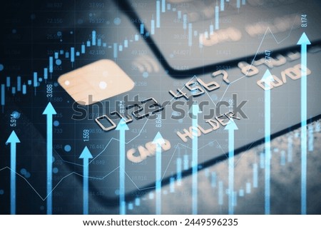 Close up of bank card with growing blue vertical arrows and candlestick forex chart on blurry index grid background. Economic growth and increase concept. Online banking concept. Double exposure