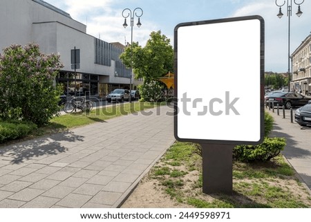 Blank Outdoor Billboard Mockup In City Alley. An Empty Poster Stand Illuminated By The Sun