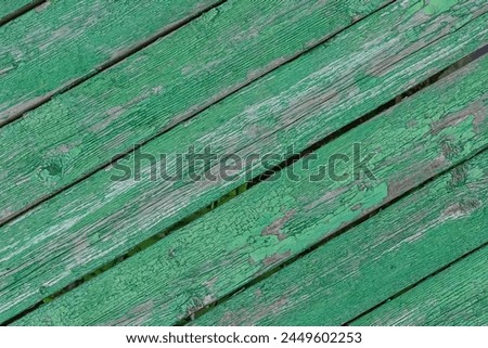 It's close up view of green painted wooden fence. It is the photo of weathered painted wood texture. It is photo of aged green fence