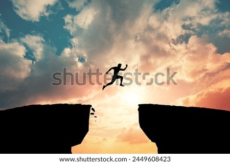 Man jump through the gap between hill. Woman jumping over cliff.