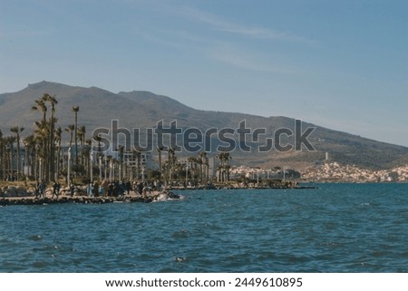 Pictures of the Moroccan city of Nador, the sea, a boat and buildings