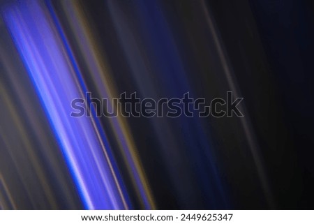 Defocused neon glow. Overlaying linear highlights. Futuristic LED lighting. Color blur on dark abstract background