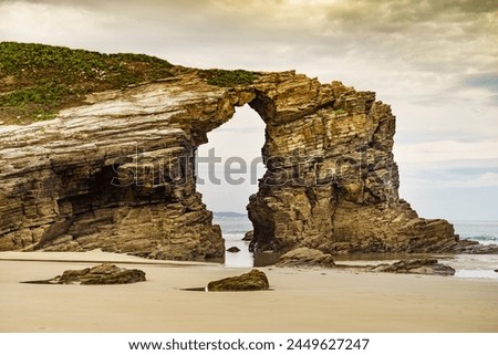 Beach of the Cathedrals, Playa las Catedrales in Ribadeo, province of Lugo, Galicia. Cliff formations on Cantabric coast in northern Spain. Tourist attraction. Royalty-Free Stock Photo #2449627247