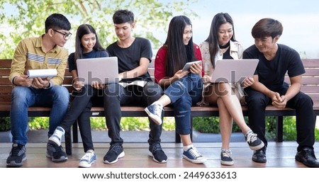 Group of Asian students are using laptops to use social media and search for information on the network. Technology, Network, Wifi Connect