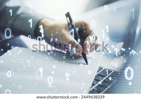 Creative concept of binary code illustration and hand writing in notebook on background with laptop. Big data and coding concept. Multiexposure