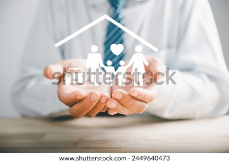 Elevating family concept, Businessman protective gesture resonates with young family silhouette. Health and house insurance icons accentuate safety, reinforcing support and care. Family life insurance