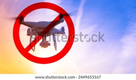 Ban on quadcopter flights. Crossed out drone flies in sky. Quadcopter with camera. Drone taking aerial photographs. Spy quadcopter at sunset. Sign prohibiting use of civilian drones. Quad copter ban Royalty-Free Stock Photo #2449653167