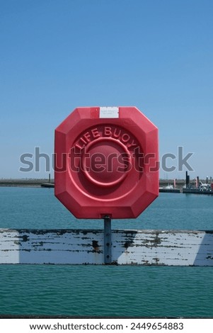 a buoy is attached to the wooden beam at the waters edge
