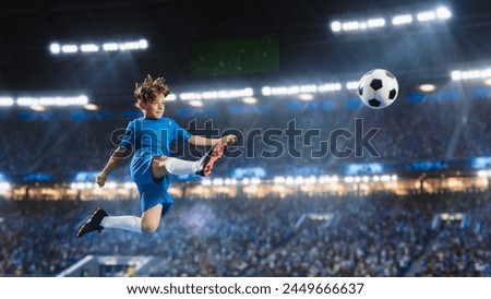 Aesthetic Shot Of Athletic Child Soccer Football Player Jumping And Kicking Ball Mid-Air On Stadium WIth Crowd Cheering. Young Boy Scoring Winning Goal on Junior World Championship Tournament Match. Royalty-Free Stock Photo #2449666637