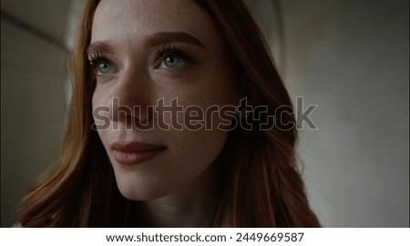 Portrait of young redhead caucasian woman standing outdoors looking forward, lifestyle, copy space. Freckled face. Photo in cold tones
