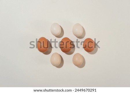 Plenty eggs arranged neatly on minimals white background in center of picture. Cooking concept for designing of product made from egg