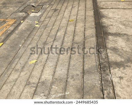 The background is a detailed concrete road lined with locks