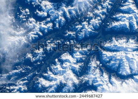 Snow-covered mountain range in Austria. Digital enhancement of an image by NASA