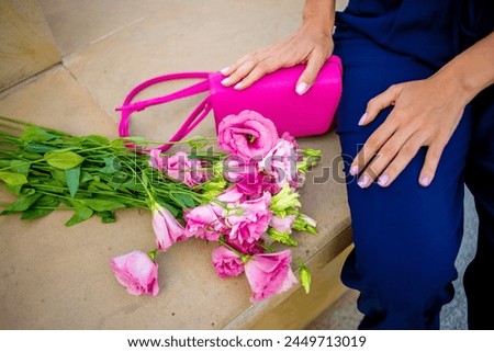 A delicate capture of a girl's hands and pink flowers. The soft petals contrast beautifully with her skin, conveying a sense of gentleness and femininity. The focus on the flowers