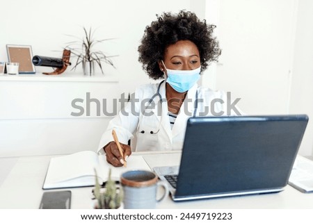 Covid 19, laptop and doctor with notebook writing summary of corona virus research, medicine report or healthcare information. Fast busy hospital, medical study or clinic nurse or black woman working