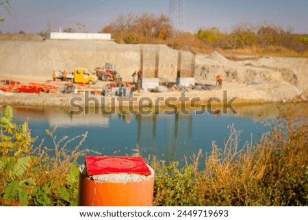 Red metal pole, side device, for determine level of bridge, 4 points for determining exact dimensions and check elevations. Construction of the bridge is in progress. Royalty-Free Stock Photo #2449719693
