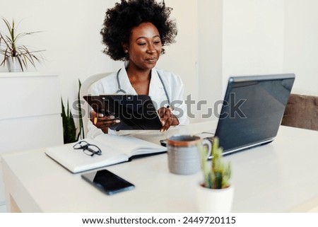 Cropped portrait of an attractive young female doctor taking notes while making a phonecall in her office. 