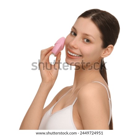Washing face. Young woman with cleansing brush on white background