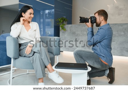 Young beautiful model posing for professional photographer in studio