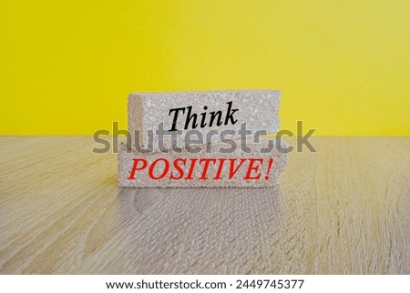 Think positive symbol. Concept words Think positive on beautiful brick blocks. Beautiful yellow background. Business, motivational think positive thinking concept. Copy space. Royalty-Free Stock Photo #2449745377