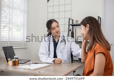 Female doctor and elderly female patient consulting about health problems in clinic