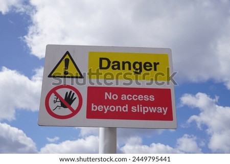 Danger sign warning no access beyond slipway at boating harbour 