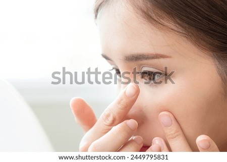 Optimise vision by contact lens, Close-up of woman face during insert contact lens to her eyes. Royalty-Free Stock Photo #2449795831