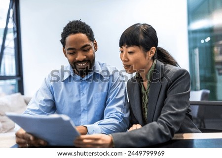 Multiethnic couple buys an apartment from a real estate agency. Royalty-Free Stock Photo #2449799969